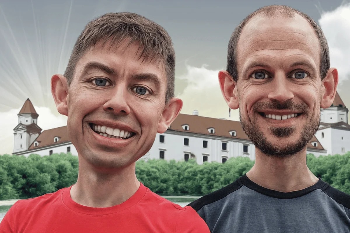 Two men in red and black shirts with an historical building and greenery in the background.