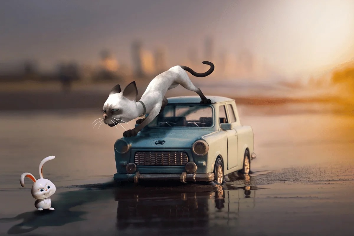 A curious Siamese cat on top of a vintage toy car staring at a small, white cartoon rabbit on a reflective surface."